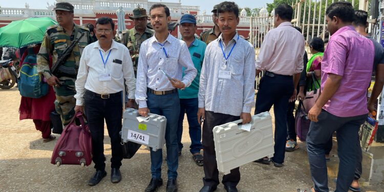 Polling officials transporting EVMs, essential equipment and materials to their designated polling stations